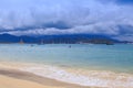 Wave Surf on Golden Beach Distant Hotel Sky Clouds Royalty Free Stock Photo