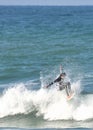 Wave surfer rides within a splash