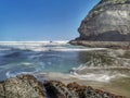 Wave swirls on the rocky ocean coast near Auckland in New Zealand Royalty Free Stock Photo