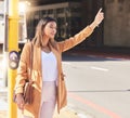 Wave, taxi and woman in city for cab, transportation and commute travel in cbd for business or meeting. Person, hand and Royalty Free Stock Photo