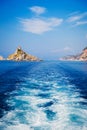 Wave trace tails of speed boat on blue water surface in the sea