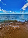 Wave water around the rocks at the coastline. Beautiful seascape background with sea and beach. Kitesurf spot. Ocean beach algae Royalty Free Stock Photo