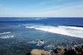 Waves against a sea horizon under a blue sky at Miyakojima, Japan Royalty Free Stock Photo