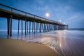 Waves in the Atlantic Ocean and the fishing pier at twilight, in Royalty Free Stock Photo