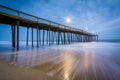 Waves in the Atlantic Ocean and the fishing pier at twilight, in Royalty Free Stock Photo