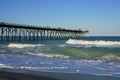 Waves on the beach at Kure Beach Pier on the North Carolina coast Royalty Free Stock Photo