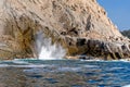 Waves and blow hole on rocks Royalty Free Stock Photo