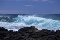Waves break on black volcanic rocks Royalty Free Stock Photo