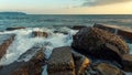 Waves break on coastal stones