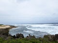 Waves break and crash towards the Kaneakua Cove Royalty Free Stock Photo