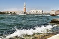 Waves break on the island of San Giorgio Maggiore, with Piazza San Marco in the background, Venice, Italy