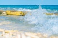 Waves break over coral shelf on edge of island splashing in air Royalty Free Stock Photo