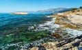 Waves break on rocky shore. Raging sea an elemental power in storm. Clear day at sea coast.