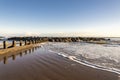 Waves break through a scenic small breakwater structure at Aberdeen city beach in a beautiful sunny day, Scotland Royalty Free Stock Photo