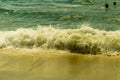 Waves breaking on a beach, with sun and blue sea in Ecuador.