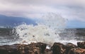 Waves breaking on big rocks, storm on the black sea in cloudy day Royalty Free Stock Photo