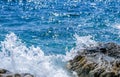 Waves are breaking on coastal stones in the summer