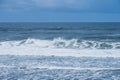 Waves breaking gently against the shore at Moledo Portugal