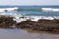 Waves Breaking over Rocks Covered with Seaweed and Barnacles