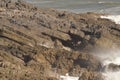 Waves breaking over rocks near Mumbles, Wales, UK