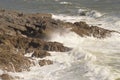 Waves breaking over rocks near Mumbles, Wales, UK