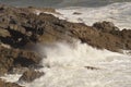 Waves breaking over rocks near Mumbles, Wales, UK