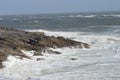 Waves breaking over rocks near Mumbles, Wales, UK