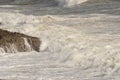 Waves breaking over rocks near Mumbles, Wales, UK