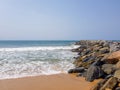 Waves breaking on rocks in a breakwater. Marine conservation and protection of the shoreline. Royalty Free Stock Photo