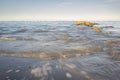 Waves breaking on the rocks and the sandy beach Royalty Free Stock Photo