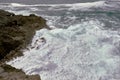 Waves breaking on the rocks at the shore of the beach Royalty Free Stock Photo