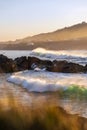 Waves breaking on the sea near the beach at sunset. Royalty Free Stock Photo