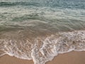 Waves breaking on the shore at dusk