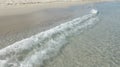 The waves cover a sandy coast