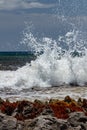 Waves crash against rocks in caribbean sea Royalty Free Stock Photo