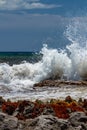 Waves crash against rocks in caribbean sea Royalty Free Stock Photo