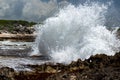 Waves crash against rocks in caribbean sea Royalty Free Stock Photo