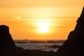 Waves crash against the rocks at sunset at Rialto Beach, Washington, US Royalty Free Stock Photo