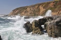 Waves crash on coastal rocks Royalty Free Stock Photo