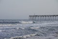 Waves crash on the pier on a stormy evening, Ocean City, Maryland, USA Royalty Free Stock Photo