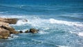 Waves crashing against a breakwater on the beach during a day Royalty Free Stock Photo