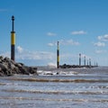 Waves crashing against breakwater at entrance to bay, Sea Palling, Norfolk