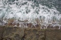 Waves crashing against the quarried stones of the breakwater