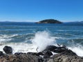 Waves crashing against rocks at Deception Pass park in summer Royalty Free Stock Photo