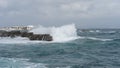 waves crashing against the rocks on a windy day Royalty Free Stock Photo