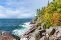 Waves splashing against the rocky shoreline of Lake Superior in autumn Royalty Free Stock Photo