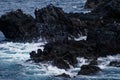 Waves crashing against volcanic rocks in Porto Moniz, Madeira Portugal