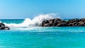 Waves crashing on the barriers made of large rocks at the resort community of Ko Olina