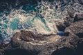 Waves crashing breaking on the rocks. Drone aerial sea surface view Royalty Free Stock Photo