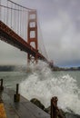 Waves crashing at the famous Golden Gate bridge with low fog rolling in San Francisco, California Royalty Free Stock Photo